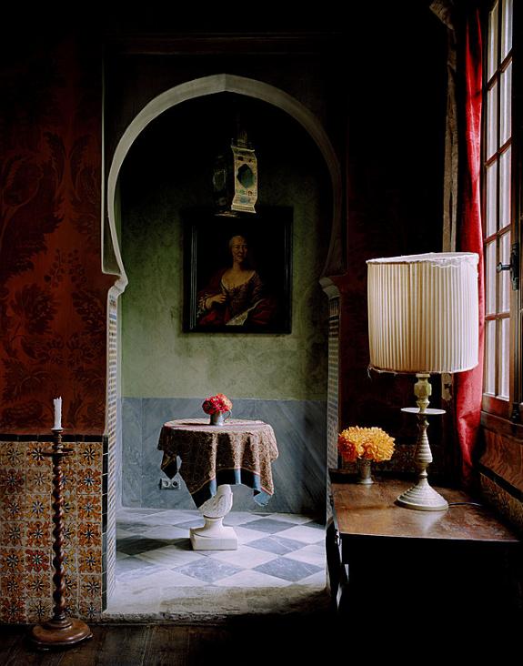 Atmospheric vintage interior with a red curtain, antique mirror, and warm light